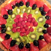 A beautiful fruit tart pinwheel on top of vanilla custard brings sweet and tart to life
